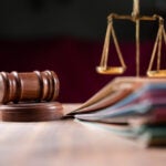 focus on hammer, group of files on judge table covered with dust - concept of pending old cases or work at judicial court settlement