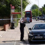 Police talking to members of the public at the scene in Hainault, north east London.
