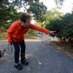 Florence Slatkin, with her dog Paco, points to the spot where she and a friend discovered a dead bear cub in New York's Central Park.