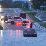 A BMW sedan is stalled in high water along southbound US Alt 19 in Tarpon Springs, Fla., Monday morning.