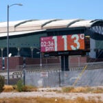 A billboard redisplays a temperature of 113 degrees Fahrenheit.