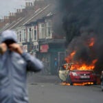 A car burns during an anti-immigration protest in Middlesbrough, England, Sunday Aug. 4, 2024.
