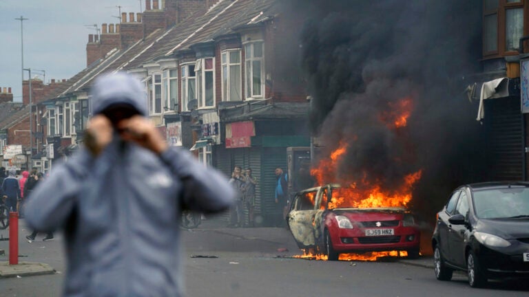 A car burns during an anti-immigration protest in Middlesbrough, England, Sunday Aug. 4, 2024.