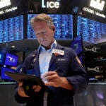 Trader Robert Charmak works on the floor of the New York Stock Exchange, Monday, Aug. 5, 2024.