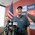 Gov. Tim Walz of Minnesota speaks to reporters at a canvassing event for the Democratic presidential ticket in St. Paul, Minn.