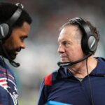 Jerod Mayo and Bill Belichick talk on the sidelines during a game against the Miami Dolphins in 2022. Mayo recently took over for Belichick as head coach of the New England Patriots.