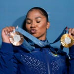 Jordan Chiles, of the United States, holds up her medals after the women's artistic gymnastics individual apparatus finals Bercy Arena at the 2024 Summer Olympics.