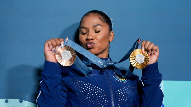 Jordan Chiles, of the United States, holds up her medals after the women's artistic gymnastics individual apparatus finals Bercy Arena at the 2024 Summer Olympics.