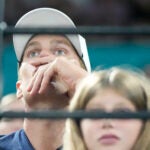 Retired American NFL football star Tom Brady, right, watches during the artistic gymnastics individual apparatus finals at Bercy Arena at the 2024 Summer Olympics.