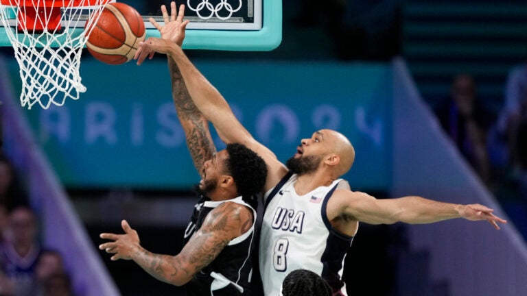 Derrick White, of the United States, blocks the shot of Carlik Jones, of South Sudan, in a men's basketball game at the 2024 Summer Olympics.