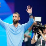 Former Olympic champion Michael Phelps, from the United States, waves to fans ahead of the evening swimming session at the 2024 Summer Olympics.